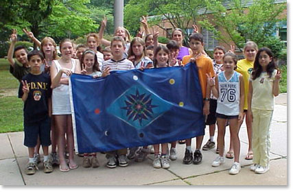 Kids Holding the Bluflag In Front of Elementry School